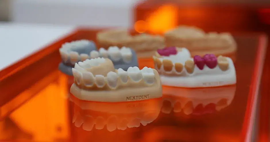 an assortment of 3D printed dental molds, dentures and dental parts